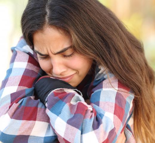 Sadly is an adverb that can be used to describe that a person did something while in a melancholy state.