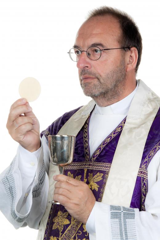 Priest showing wine and bread to the parish as part of Holy Communion.